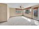 Inviting living room featuring neutral carpeting, three windows and a ceiling fan at 18736 E Powers Pl, Aurora, CO 80015