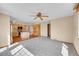 Open concept living room with hardwood floors, a ceiling fan, and a view into the kitchen at 18736 E Powers Pl, Aurora, CO 80015