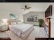 Relaxing bedroom features plush king bed, fireplace, and backyard view at 18736 E Powers Pl, Aurora, CO 80015