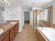Primary bathroom with double vanity, soaking tub, and shower at 6356 Blue Water Cir, Castle Rock, CO 80108