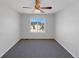 Simple bedroom with ceiling fan and window overlooking the driveway at 6356 Blue Water Cir, Castle Rock, CO 80108