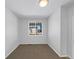 Bright bedroom with carpet flooring and a large window offering natural light at 6356 Blue Water Cir, Castle Rock, CO 80108