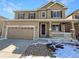 Two-story house with a brown exterior, two-car garage, and small front porch at 6356 Blue Water Cir, Castle Rock, CO 80108