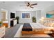 Virtually staged main bedroom with a large bed and en-suite bathroom at 6356 Blue Water Cir, Castle Rock, CO 80108