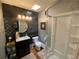 Modern bathroom featuring a vanity with a round mirror, a toilet, and a glass-enclosed shower at 421 E Alameda Ave, Denver, CO 80209