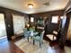 Inviting dining room with stylish decor, dark walls, and a glass-topped table set on a patterned rug at 421 E Alameda Ave, Denver, CO 80209
