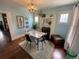 Charming dining area with a marble-top table, chandelier, and fireplace at 421 E Alameda Ave, Denver, CO 80209