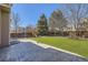 Landscaped backyard featuring a stone patio, an artificial lawn, and play structure at 10273 Bentwood Ln, Highlands Ranch, CO 80126