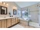 Bathroom with soaking tub, glass-enclosed shower, and double sinks, offering a spa-like experience at 10273 Bentwood Ln, Highlands Ranch, CO 80126