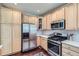Well-lit kitchen featuring stainless steel appliances, plentiful cabinets, and stone countertops at 10273 Bentwood Ln, Highlands Ranch, CO 80126