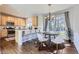 Modern kitchen with stainless steel appliances, island seating, and an adjacent dining area at 10273 Bentwood Ln, Highlands Ranch, CO 80126