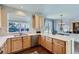 Well-lit kitchen with stone countertops, stainless steel sink, modern appliances, and lots of cabinet storage at 10273 Bentwood Ln, Highlands Ranch, CO 80126
