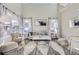 Bright and airy living room with modern decor, large windows, and comfortable seating at 10273 Bentwood Ln, Highlands Ranch, CO 80126