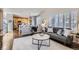 Open-concept living room adjacent to kitchen featuring a comfortable seating area and stylish decor at 10273 Bentwood Ln, Highlands Ranch, CO 80126