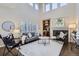 Bright living room with vaulted ceiling, fireplace, and large windows with plantation shutters at 10273 Bentwood Ln, Highlands Ranch, CO 80126