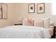 Comfortable bedroom with plush bedding, decorative pillows, and stylish nightstands with modern lamps at 5882 W Chestnut Ave, Littleton, CO 80128