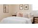 Comfortable bedroom with plush bedding, decorative pillows, and stylish nightstands with modern lamps at 5882 W Chestnut Ave, Littleton, CO 80128