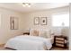 Comfortable bedroom with plush bedding, decorative pillows, and stylish nightstands with modern lamps at 5882 W Chestnut Ave, Littleton, CO 80128