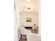 A dedicated and designed alcove for work featuring a floating shelf, sleek desk and comfortable white chair at 5882 W Chestnut Ave, Littleton, CO 80128