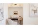 Stylish desk nook with floating shelf, modern desk, and charming decor, providing a functional workspace at 5882 W Chestnut Ave, Littleton, CO 80128