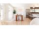 Inviting dining room with light wood floors, white walls, and an open view into the kitchen at 5882 W Chestnut Ave, Littleton, CO 80128