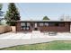 Brick home featuring a modern design, a well-manicured lawn and a spacious patio at 5882 W Chestnut Ave, Littleton, CO 80128