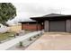 The home features modern architectural details, a well-kept lawn, and updated landscaping at 5882 W Chestnut Ave, Littleton, CO 80128