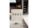 This features a modern front door with glass inserts and a contrasting brick and siding exterior at 5882 W Chestnut Ave, Littleton, CO 80128