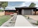 Charming single-story home with a well-manicured front yard and a modern concrete walkway at 5882 W Chestnut Ave, Littleton, CO 80128