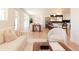 Open concept living area with hardwood floors, white furnishings, a dining nook, and a view of the kitchen at 5882 W Chestnut Ave, Littleton, CO 80128