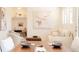 Bright living room area with neutral-toned furniture, a stylish painting on the wall, and a small desk at 5882 W Chestnut Ave, Littleton, CO 80128