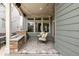 Cozy covered back patio with stone fireplace and outdoor seating, perfect for entertaining at 6723 Raritan Dr, Denver, CO 80221