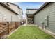 Well-maintained backyard with artificial grass and covered patio, ideal for relaxation at 6723 Raritan Dr, Denver, CO 80221