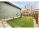 Low-maintenance backyard with artificial grass, perfect for outdoor activities and easy upkeep at 6723 Raritan Dr, Denver, CO 80221