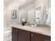 Bathroom features a vanity with a light countertop, dark cabinets, a modern faucet, and a mirror at 6723 Raritan Dr, Denver, CO 80221