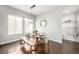 Dining room boasts modern lighting and design, seats six with bench, and ample natural light at 6723 Raritan Dr, Denver, CO 80221