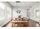 Bright dining area features modern light fixture, seating for six, and natural light at 6723 Raritan Dr, Denver, CO 80221