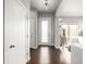 Entryway with hardwood floors and a modern light fixture, providing a welcoming entrance to the home at 6723 Raritan Dr, Denver, CO 80221