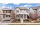 Charming two-story home featuring a red front door, well-maintained yard, and inviting curb appeal at 6723 Raritan Dr, Denver, CO 80221