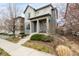 Charming two-story home featuring a covered front porch and landscaped front yard at 6723 Raritan Dr, Denver, CO 80221