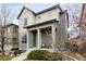 Attractive two-story home featuring a welcoming front porch, neatly landscaped yard, and curb appeal at 6723 Raritan Dr, Denver, CO 80221