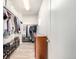A spacious walk-in closet includes built-in storage, shelving, and wooden floors for organized clothing and accessories at 6723 Raritan Dr, Denver, CO 80221
