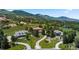 Expansive aerial view showcasing the property's landscaping, neighborhood, and mountain views in the background at 69 N Ranch Rd, Littleton, CO 80127