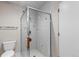 Clean bathroom with a glass-enclosed shower, white tile, and modern fixtures at 69 N Ranch Rd, Littleton, CO 80127