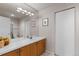 Bright bathroom features a double sink vanity, a large mirror, and ample storage space at 69 N Ranch Rd, Littleton, CO 80127