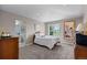 Comfortable bedroom featuring carpeted floors, a double bed, and a scenic view at 69 N Ranch Rd, Littleton, CO 80127