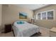 Cozy bedroom features a large window, neutral walls, and a comfortable bed with turquoise pillows at 69 N Ranch Rd, Littleton, CO 80127