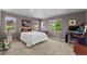 Comfortable bedroom featuring neutral tones, large windows with scenic views, and a dedicated workspace at 69 N Ranch Rd, Littleton, CO 80127