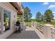Inviting deck for outdoor entertaining with grill and stunning backyard views at 69 N Ranch Rd, Littleton, CO 80127