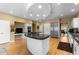 Gourmet kitchen with a rounded island, built-in appliances, and plenty of counter space at 69 N Ranch Rd, Littleton, CO 80127
